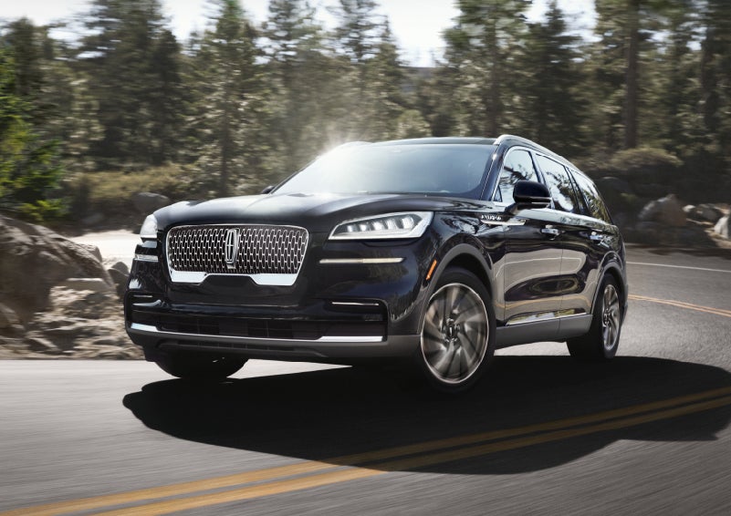 A Lincoln Aviator® SUV is being driven on a winding mountain road | Crossroads Lincoln of Southern Pines in Southern Pines NC