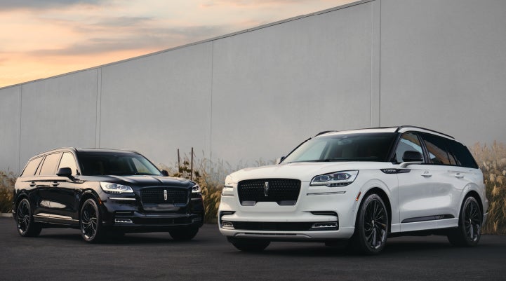 Two Lincoln Aviator® SUVs are shown with the available Jet Appearance Package | Crossroads Lincoln of Southern Pines in Southern Pines NC
